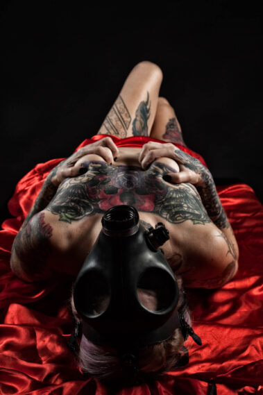 Image of Hannah Batgirl laying on red