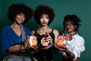 Three models holding jars of Jaytee’s Sweet & Juicy Pineapples while posing together at the MAYHEM event.