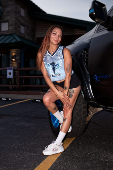 Ice Angels model posing beside a customized Ram TRX during the evening portion of the event.